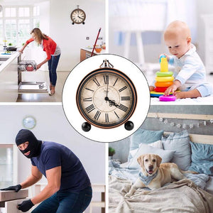 A four-part collage features a cozy kitchen, a giggling baby, a mysterious person in a balaclava, and an adorable dog on a bed. The centerpiece is the Roman Numeral Clock SpyCam, blending seamlessly into its surroundings.