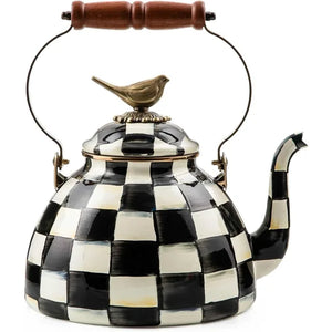 A decorative kettle in black and white checkered design with a bird on the lid top.