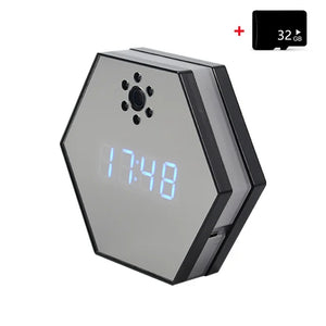 The Sleek Clock SpyCam is a hexagonal digital clock with a blue LED display showing 17:48, built-in spy camera, infrared night vision, and comes with a 32GB memory card in the top right corner.