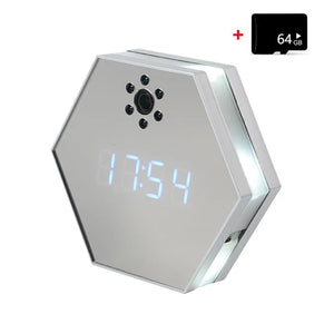 The Sleek Clock SpyCam is a hexagonal digital clock with a mirrored display showing 17:54, featuring a spy camera lens above the display, 4K HD video clarity, and a 64GB memory card in the top right corner.