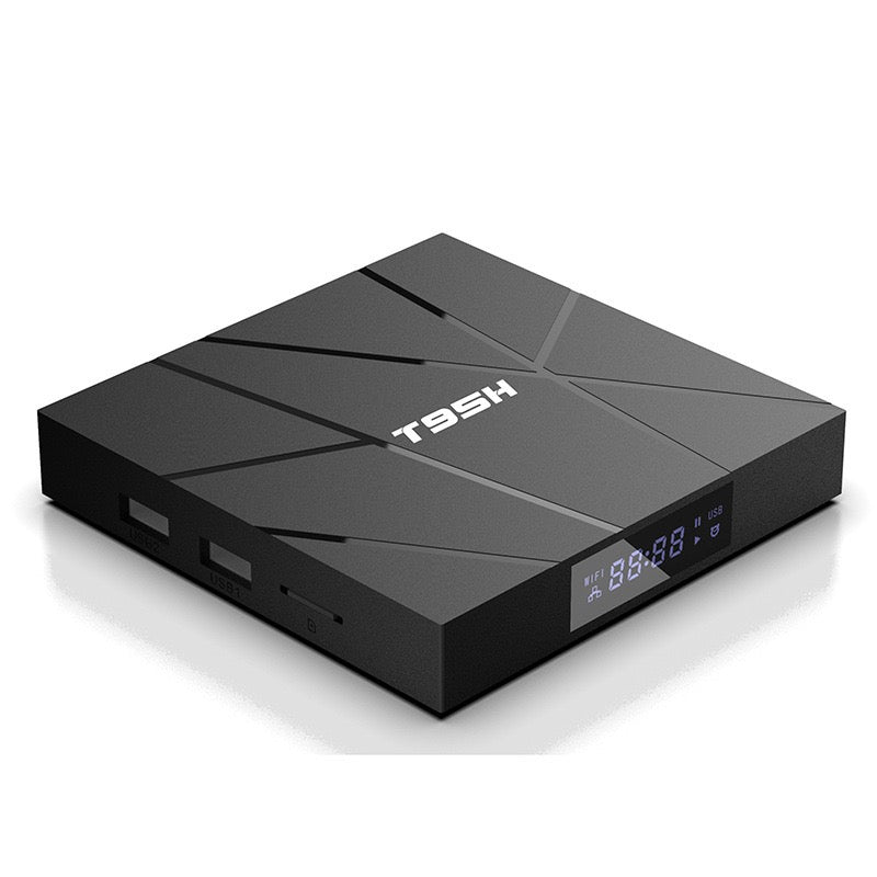 Sleek black Android TV Box SpyCam with angular design, digital front display, and multiple USB and card ports on the side for enhanced connectivity.