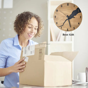 A person beams with joy as they open a cardboard box, revealing the Wooden Round Wall Clock with its rustic modern appeal, natural wood finish, and abstract design. The clock is proudly displayed on the wall, featuring the phrase "Best Gift.