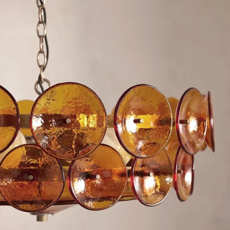 The Italian Retro Pendant Light, with circular amber glass discs and a mid-century modern design inspired by Italian artisan lighting, hangs from a metal chain against a plain light background.