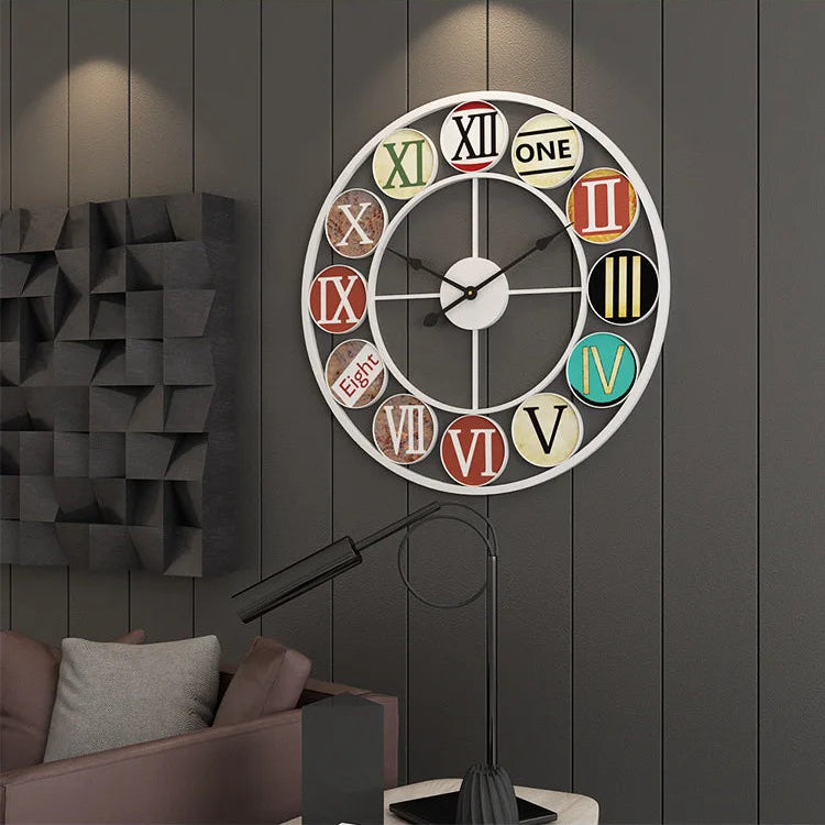 The Nordic Color-Ring Wall Clock, featuring vibrant mismatched numbers, hangs on a dark paneled wall above a contemporary sofa and lamp.