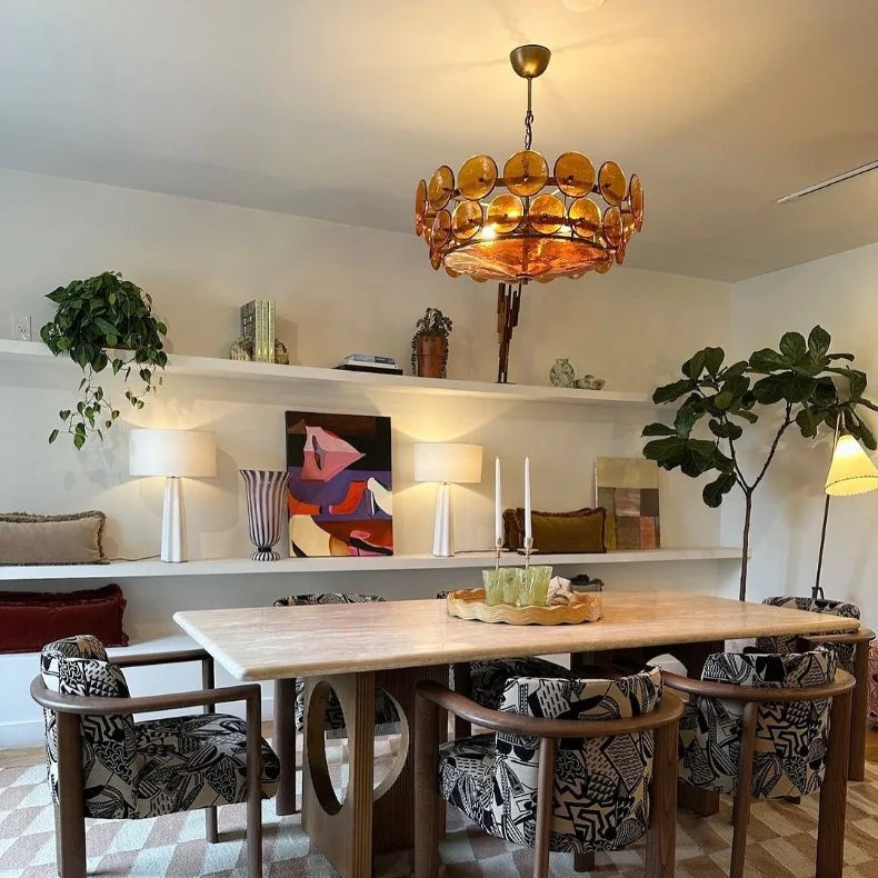 A dining room features a large wooden table, six patterned chairs, an Italian Retro Pendant Light, geometric rug, built-in shelves, two table lamps, and a potted plant in the corner.