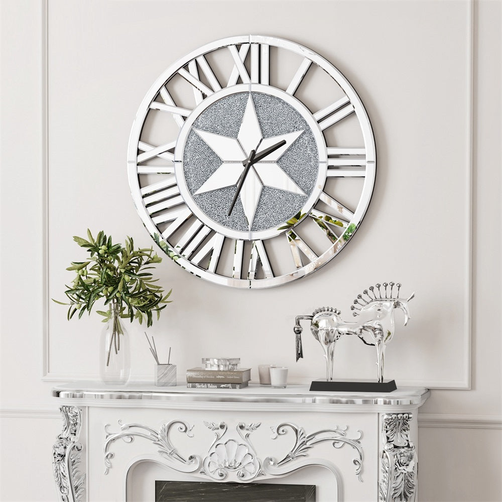 The Astral Chic Roman Wall Clock, with its silvery finish and star design, hangs above a white ornate mantel adorned with a leafy plant and silver horse figurines.