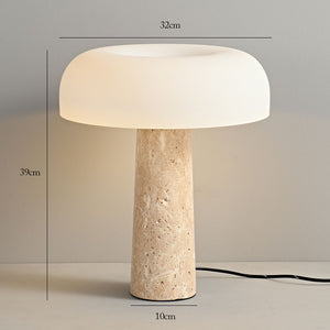 The Mushroom Desk Lamp features a white, dome-shaped shade and a beige natural stone base. Providing organic desk lighting, it stands 39cm high and 32cm wide, with a 10cm diameter base. The cord is visible at the base.