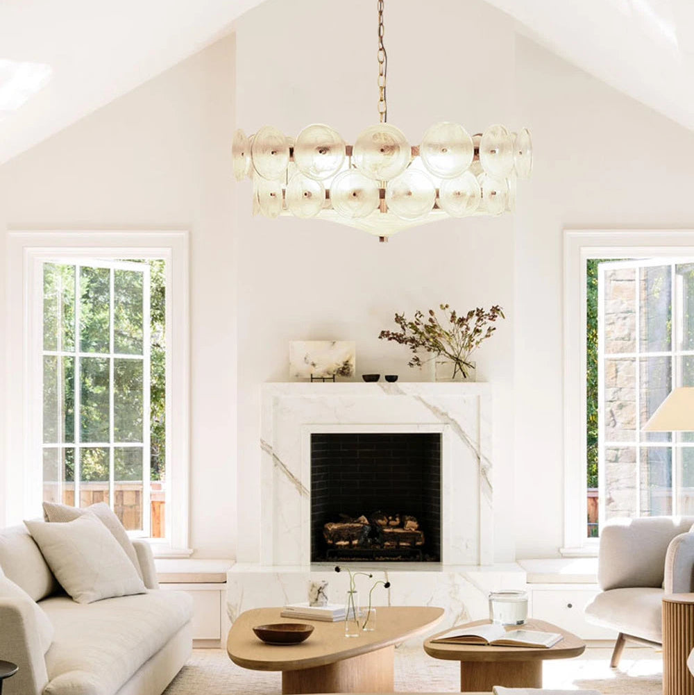 Bright living room with two large windows, marble fireplace, light sofas, wood coffee table, minimalist decor, and the Italian Retro Pendant Light as an elegant centerpiece.