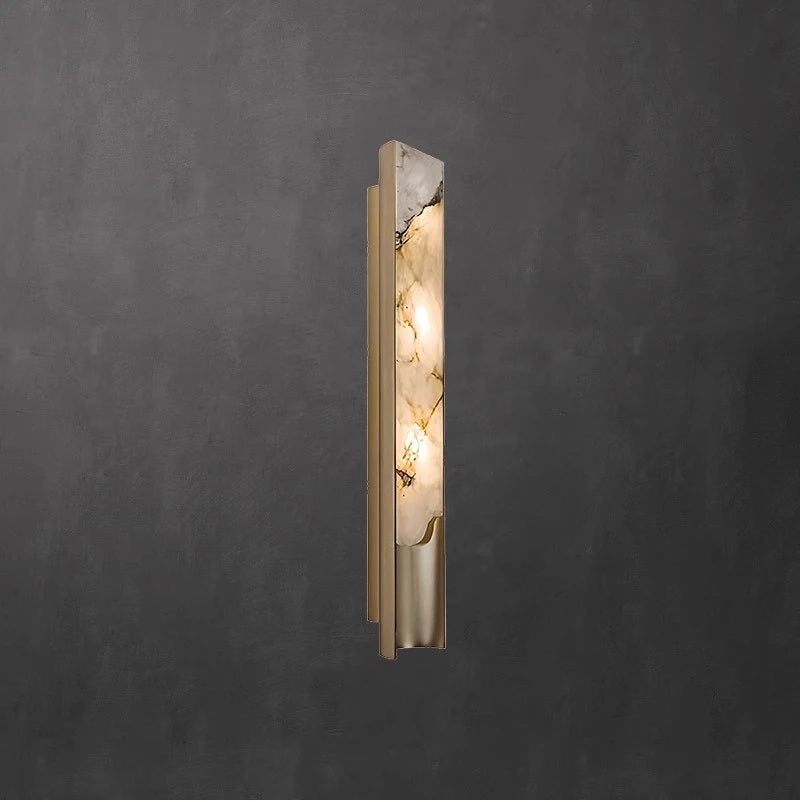 The Luxury Marble Wall Sconce features a gold frame and a marbled glass cover that emits a soft, inviting light. Mounted on a dark textured wall, this fixture brings timeless elegance to any interior space.