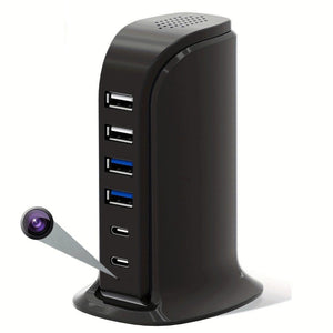 The SpyCam Charger Hub (USB & Type-C Ports) is a black USB charging hub with multiple ports and a hidden camera lens at the bottom front, perfect for discreet home monitoring.
