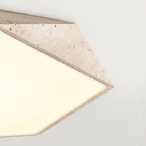 Natural Stone Ceiling Light with a textured travertine frame and a soft, diffused white glow, mounted against a plain white ceiling.