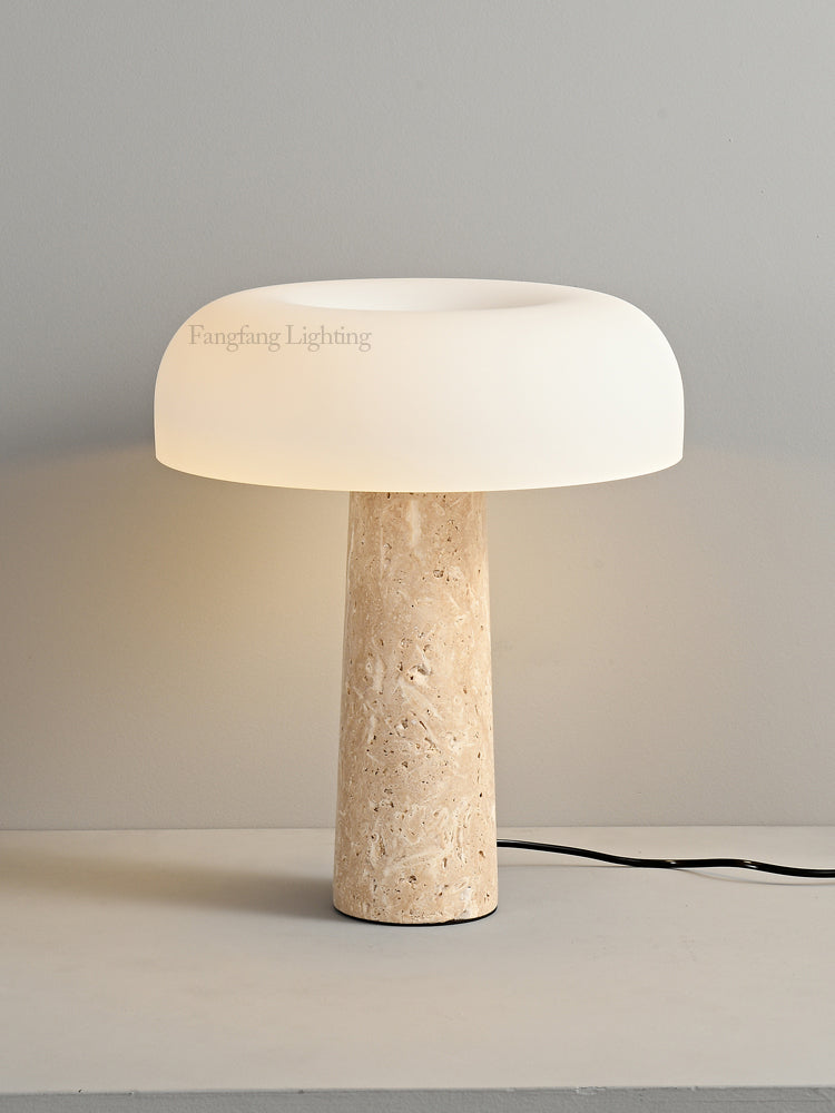 Introducing the Mushroom Desk Lamp—a sleek and modern lighting piece featuring a white glass dome shade and a cylindrical beige stone base. Placed on a light-colored surface against a gray wall, this lamp beautifully blends organic inspiration with contemporary design for sophisticated desk lighting.