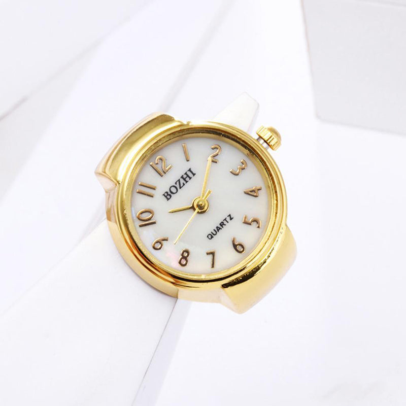 The Vintage Ring Watch features a gold finish, a white face with Arabic numerals and gold hands, blending retro style with function. This unique wearable timepiece is elegantly displayed against a white background.