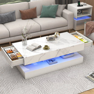 The Premium Coffee Table features a modern marble-gloss finish with open side drawers for snacks, books, cups, and decor, perfectly accenting a living room alongside a sofa and shelf.