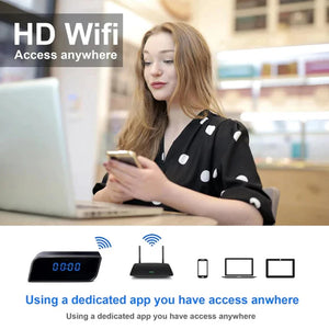 A woman uses her smartphone and laptop in a café. Text reads “SpyCam Camera Clock: HD WiFi Access Anywhere” with device icons below, highlighting Motion Detection for added security.