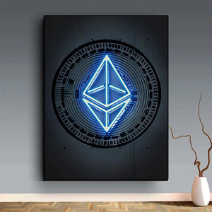 A frameless Ethereum print features a glowing blue Ethereum logo over a circuit board pattern, displayed on a gray wall above a wooden floor next to a white vase with dried branches.