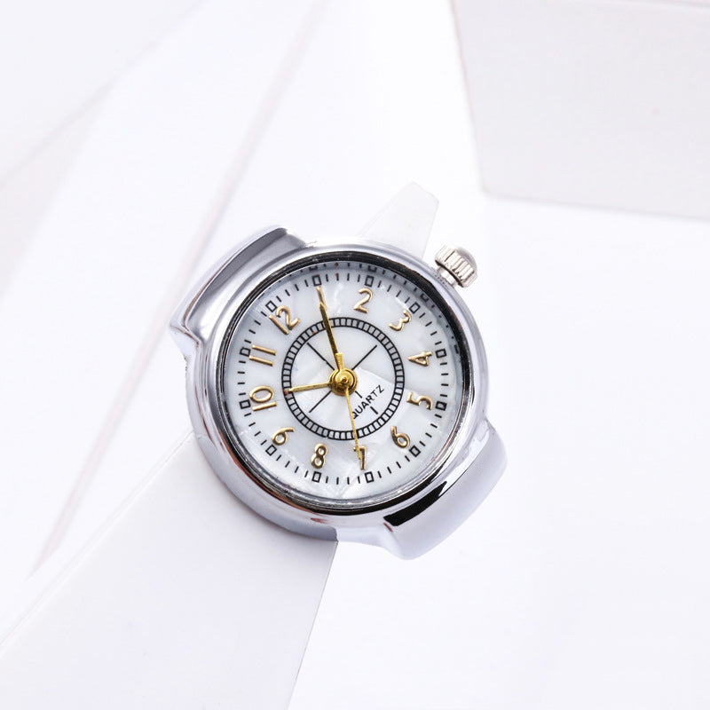 The Vintage Ring Watch is a round silver analog wristwatch with a white face, gold and black hour markers, and three gold hands, offering retro style as a classic timepiece shown against a white background.