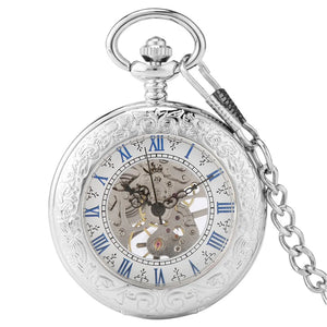 Silvery Pocket Watch featuring an ornate engraved case, blue Roman numerals, a skeleton dial displaying visible gears, and an attached chain.