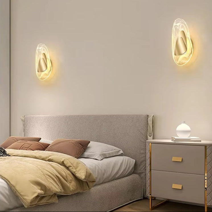 Modern bedroom with a gray upholstered bed, pillows, beige bedding, a nightstand with a lamp, and two Luxury Crystal Wall Lamps above the bed.
