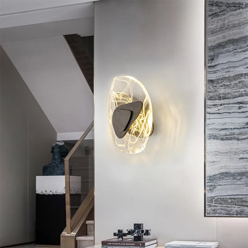 Luxury Crystal Wall Lamp featuring glowing lines, mounted on a light-colored wall near stairs and a decorative sculpture in a contemporary interior.