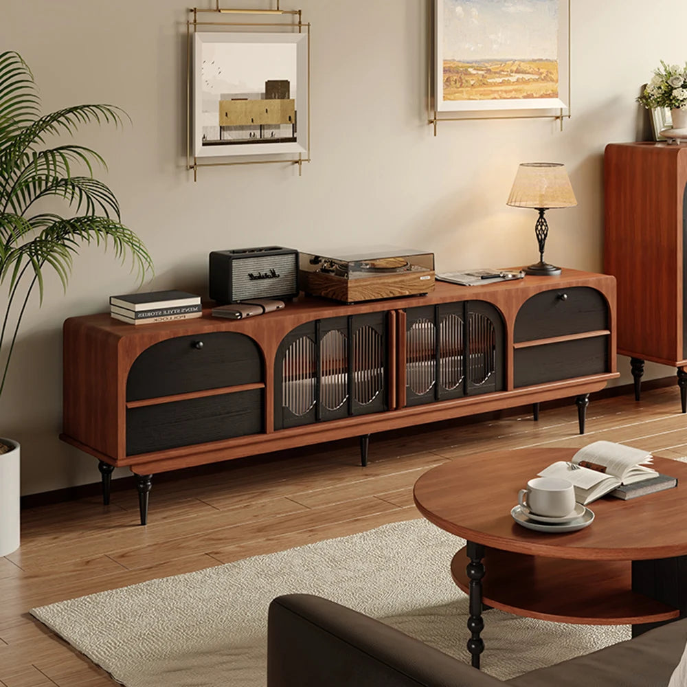 An Antique TV Cabinet Combo Set sits against a living room wall, displaying records, books, and decor. Framed art hangs above, with a lamp on one end for a stylish mid-century modern touch.