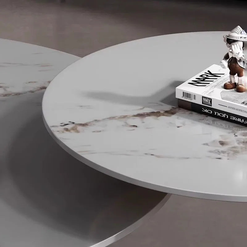 The Premium Round Coffee Table features a round design with a small figurine and two stacked books displayed on top.