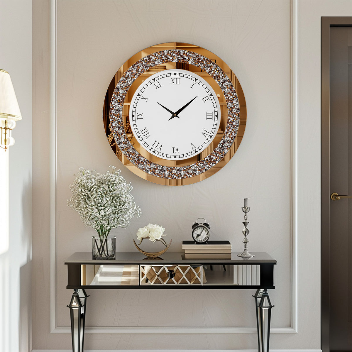 The Modern Luxury Roman Numerals Wall Clock hangs above a mirrored console table decorated with white flowers, books, and a small clock, adding elegance to the modern interior.