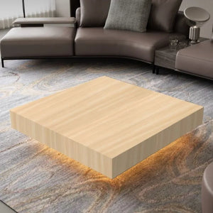 A modern living room features the Modern Luxe Coffee Table with underlighting atop a patterned rug, perfectly complementing the sectional sofa and emphasizing sleek, contemporary aesthetics.