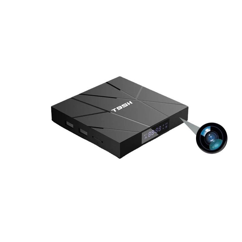 The Android TV Box SpyCam is a black device with USB ports, SD card slot, digital display, and a graphic highlighting its built-in hidden camera feature.