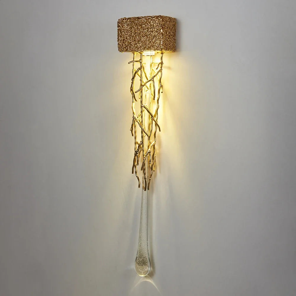 Luxury Vertical Wall Light showcases a textured square shade and intertwined branches beneath, gently casting a warm glow.