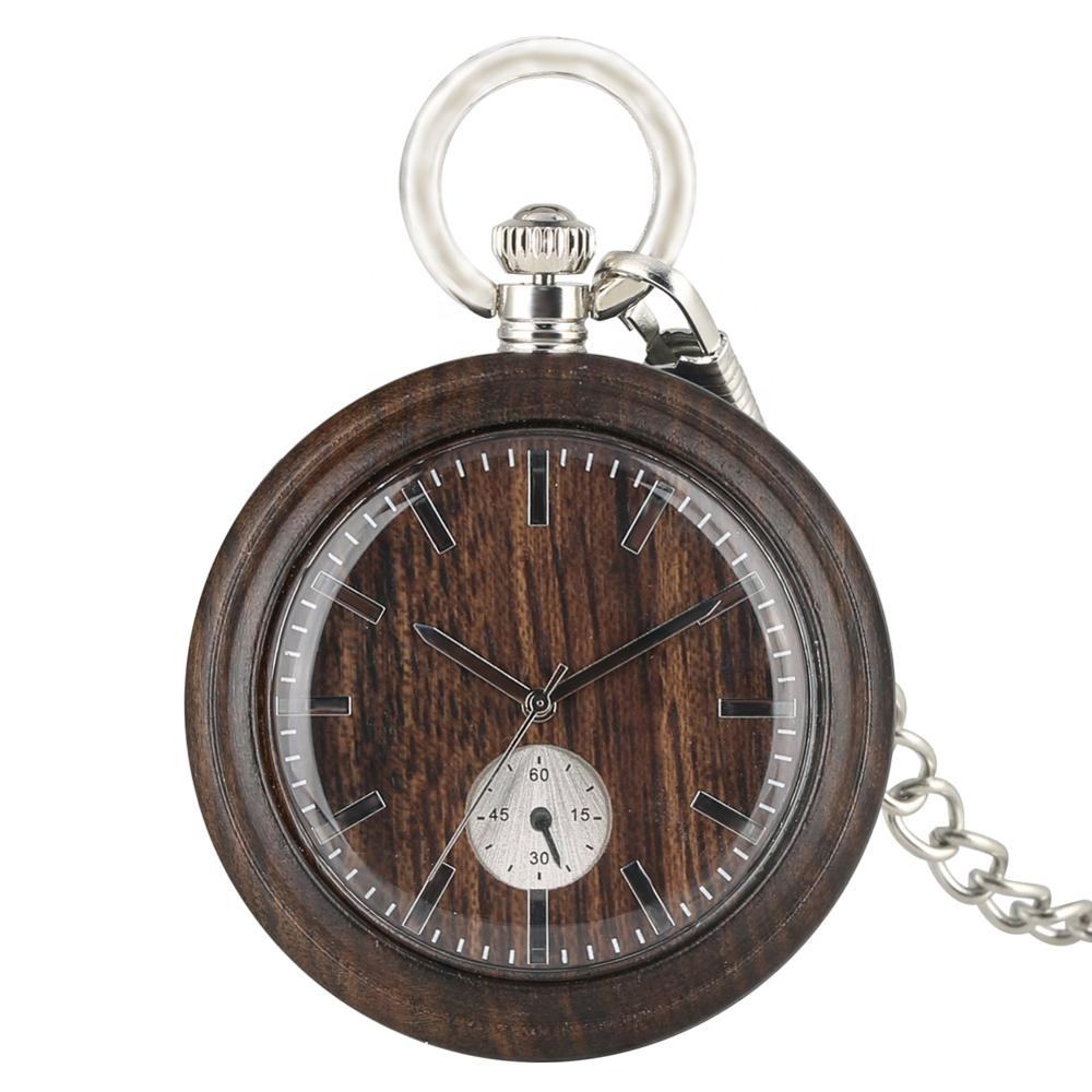 The Wood Pocket Watch features a dark wooden face, silver markings and hands, a small seconds dial, and comes with a silver chain.