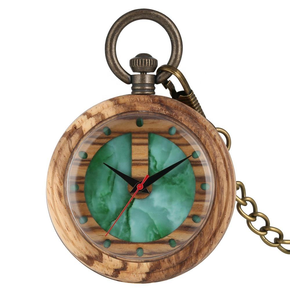 The Timeless Wooden Pocket Watch features a round wood grain case, a green marble face, gold hour markers, black and red hands, and an attached brass chain—a modern vintage-inspired timepiece.