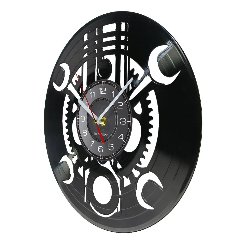 The Black Record Wall Clock features a rustic industrial design with a vinyl record aesthetic, displaying black and white colors and visible gears.