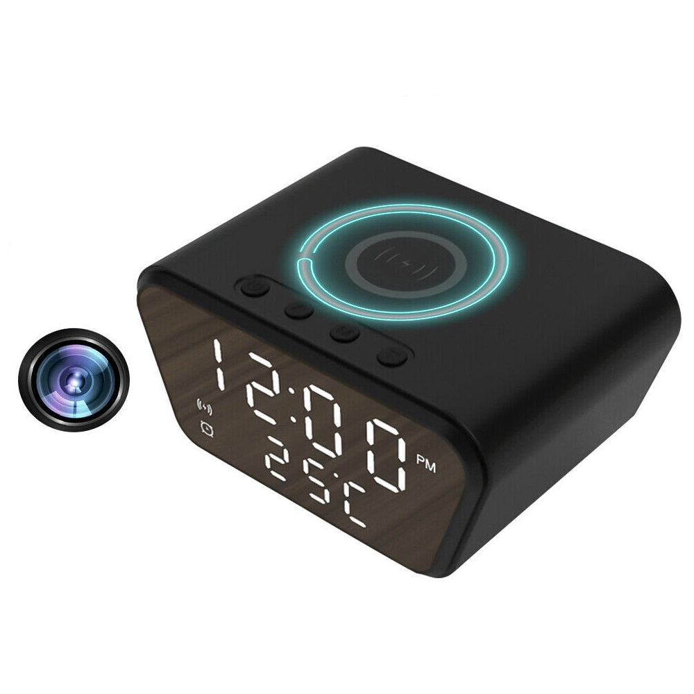 The Clock Charger SpyCam is a black digital clock displaying 12:00, FM, and 25°C with wireless charging on top. A hidden feature allows it to serve as a home surveillance tool with crisp 1080P video recording capabilities.