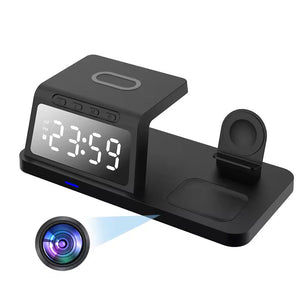 The Clock Wireless Charging Station SpyCam is a sleek black digital device that features a large 12:59 display, an integrated wireless charging pad on top, and an additional platform with a circular slot. The camera lens icon subtly indicates its hidden 4K camera capability.