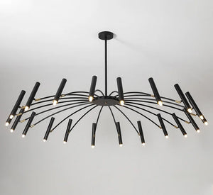 A large, black and contemporary candle style chandelier, featuring adjustable lighting, hanging in a room.