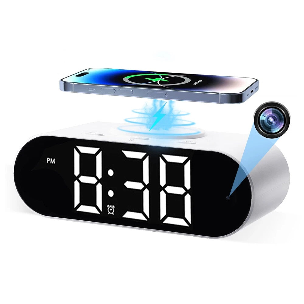 The Digital Clock Charger SpyCam features a large LED display showing 8:38 PM, wirelessly charges your smartphone on top, and has a hidden camera lens on the right side of the clock.