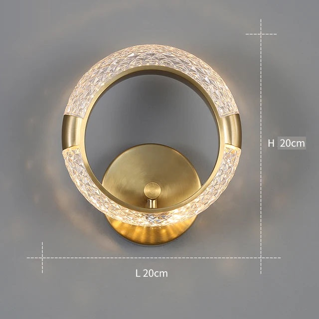 The Elegant Ring Wall Sconce, with a diameter of 20 cm and featuring a gold-colored base and a textured illuminated ring, adds an elegant touch to any space.