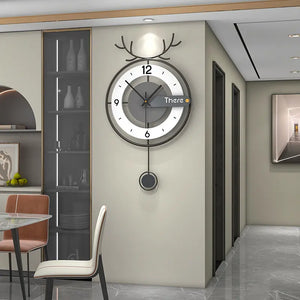 An Antler-like Wall Clock is mounted on a beige wall in a contemporary dining area, which features a table, chairs, and a cabinet displaying various items.