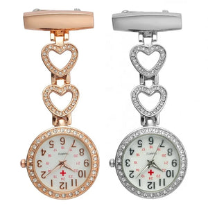 The Alloy Metal Diamond Doctor Medical Nurse Pocket Watch set includes rose gold and silver quartz watches with heart-shaped chains, rhinestone accents, and white dials with red cross symbols—stylish and functional for breast nurses.