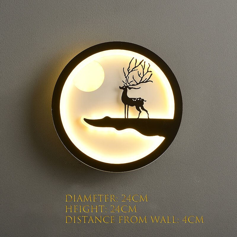 The Minimalist Wall Lamp emits a gentle and warm light, showcasing a deer silhouette on a hill set against a moonlit background. With its modern aesthetic, it measures 24cm in both diameter and height, extending 4cm from the wall—perfect for enhancing any contemporary home decor.