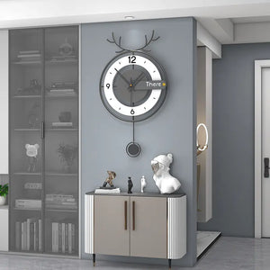 Modern interior featuring the Antler-like Wall Clock atop a cabinet adorned with decorative items. Nearby stands a glass-fronted cabinet and an adjoining doorway to another room, effortlessly merging modern style with natural elements.