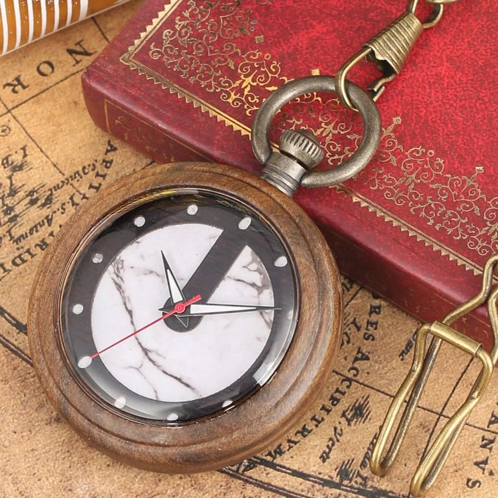 The Custom Vintage Retro Handmade Marble Dial Quartz Wood Pocket Watch Relojes De Bolsillo rests on a red ornate book beside a map and a brass tool.