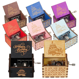 A set of nine vibrant Happy Birthday Music Boxes, each crafted from wood with an open-lid design showcasing a "Happy Birthday" cake motif. Inside every music box, there is a small, visible hand-crank mechanism.