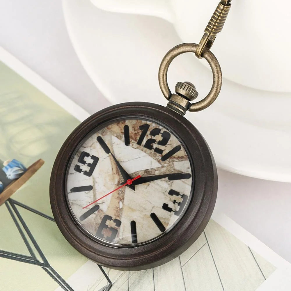 A High Quality Marble Stone Watch Dial Wooden Pocket Watch Vintage Quartz Pocket Watch rests atop a book, its weathered face and black numerals showing 10:09:36.