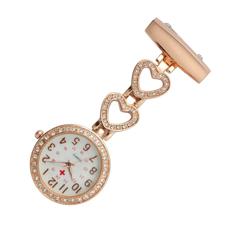 The Alloy Metal Diamond Doctor Medical Nurse Pocket Watch features a round, crystal-studded face with three heart-shaped links on a clip. This quartz breast nurse watch offers elegance and precision for daily use.