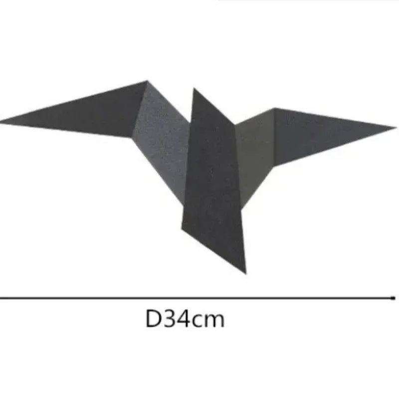 A Modern Flying Bird Wall Sconce in black, featuring a geometrical bat-shaped design with straight edges, measures 34 cm from tip to tip.