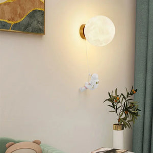An aspiring astronaut figurine appears to be floating towards a moon-shaped lamp mounted on a wall.