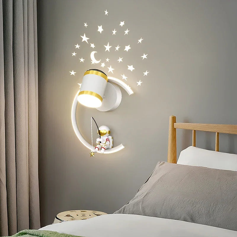 A whimsical Star Astronaut Wall Light designed to resemble a crescent moon with stars and an astronaut decoration, perfect for aspiring astronauts in a cozy bedroom setting.