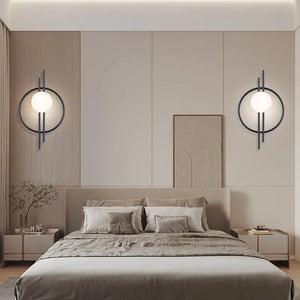 A modern bedroom with a double bed, neutral-toned bedding, two bedside tables, and two Circular Wall Sconces with Dual Vertical Rods above the headboard. A minimalist artwork is centered above the bed.